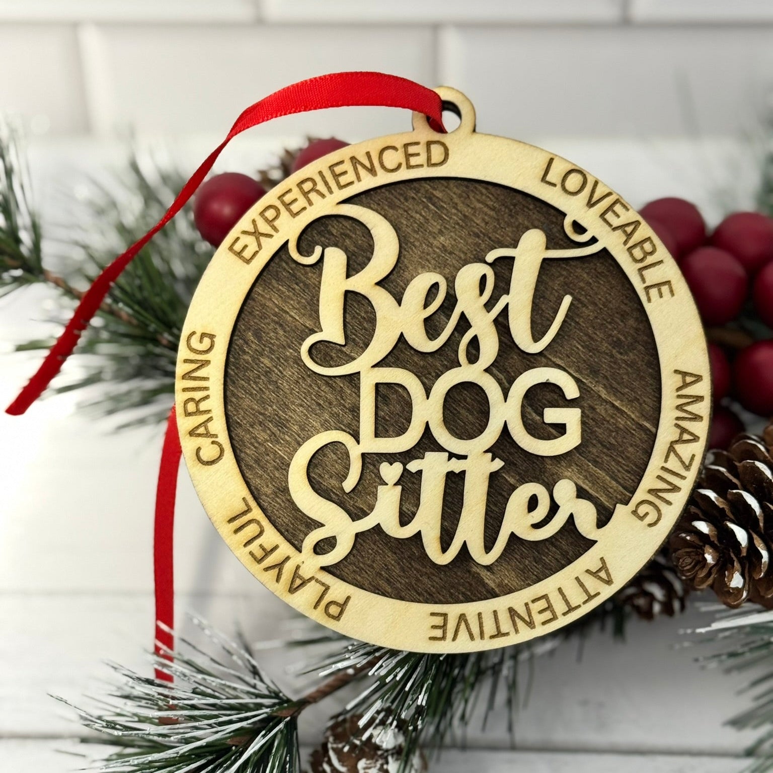 Decorative ornament with 'Best Dog Sitter' text on a Christmas tree background